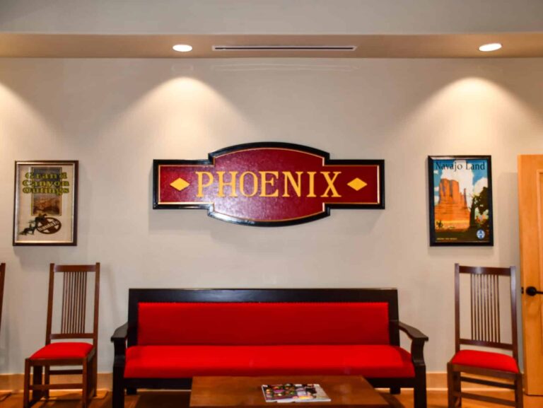 Interior view of Dental Depot's West Phoenix dentist office reception area with red furniture and a Phoenix sign