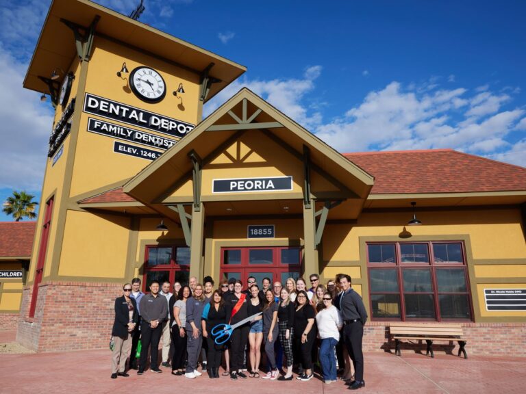 Dental Depot's Peoria dental team poses for a photo in front of the dentist office