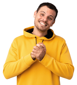 A young man in a yellow hoodies smiles big