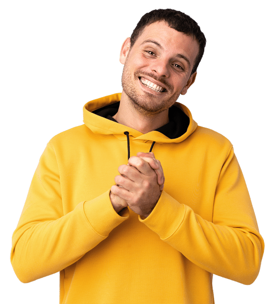 A young man in a yellow hoodies smiles big